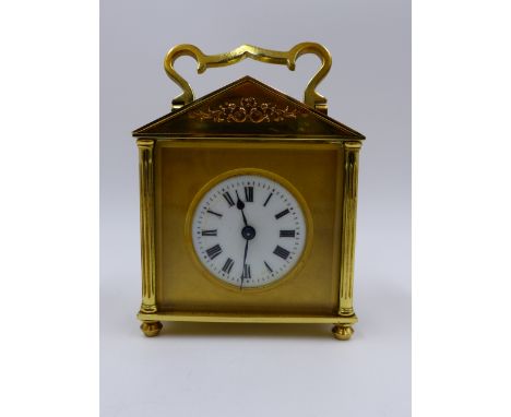 A SMALL EARLY 20th.C.BRASS CASED CARRIAGE CLOCK WITH TWIN ESCARPMENT WINDOW TO PEDIMENT TOP, COMPLETE WITH ORIGINAL LEATHER O