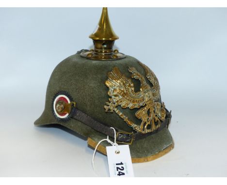 A GERMAN PICKLEHAUBE HELMET WITH GREEN CLOTH SKULL AND SPIKE FINIAL.