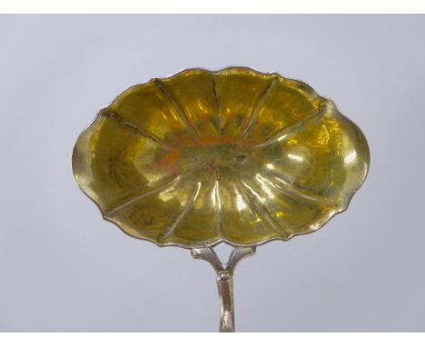 A WHITE METAL WITH GILDED DOUBLE LIPPED AND CRIMPED PUNCH LADLE WITH A TURNED WOODEN HADLE INDISTINCT MARKS TO THE BOWL.