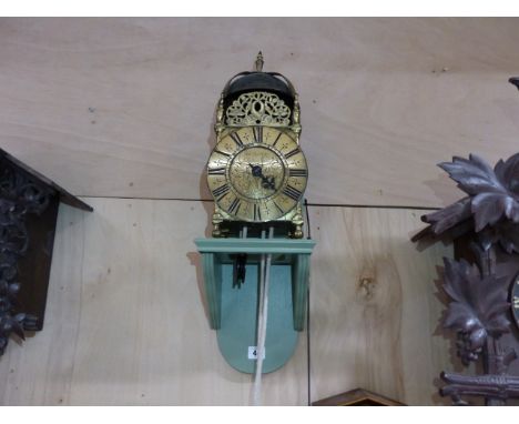 AN EARLY LANTERN CLOCK IN BRASS FRAME CASE. 6.5" DIAL SIGNED JOHN GREEN FECIT, LONDON MOUNTED ON LATER WALL BRACKETS.   THE C