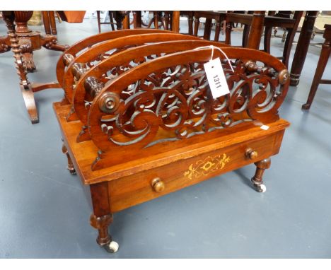 A VICTORIAN FOUR DIVISION CARVED AND INLAID WALNUT CANTERBURY WITH APRON DRAWER, RING TURNED LEGS ENDING IN CERAMIC CASTORS.