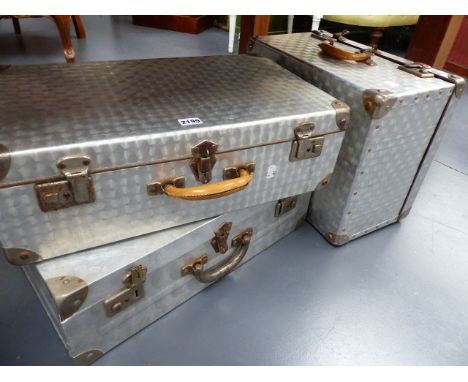 A GROUP OF THREE ALLOY TRAVEL CASES WITH POLISHED ENGINE TURNED FINISH.   (3)