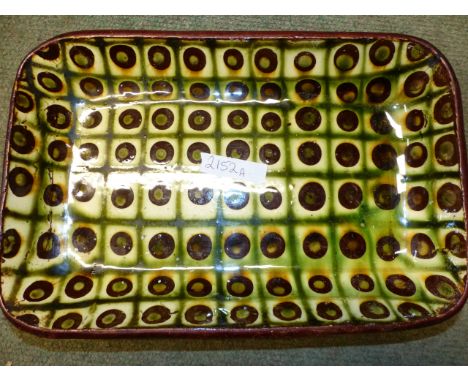TWO ART POTTERY SHALLOW RECTANGULAR DISHES WITH SLIP WARE DECORATION. INDISTINCT POTTERS MARKS TO THE BASES. (2)