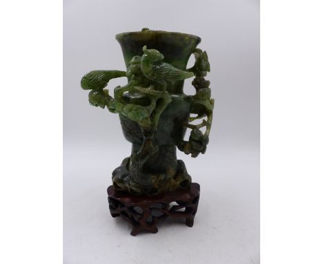 TWO CHINESE CARVED HARDSTONE VASES, A ROSE QUARTZ EXAMPLE WITH DRAGON DECORATED COVER ( H.28.5cms)   AND A GREEN JADE OR JADI