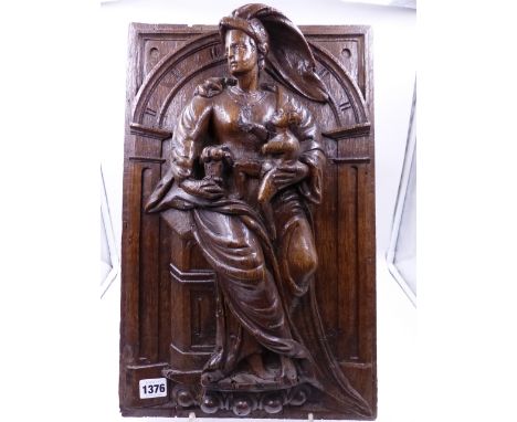 AN EARLY CARVED OAK PANEL OF A CLASSICALLY DRAPED LADY HOLDING A CHILD IN AN ARCHITECTURAL NICHE.   H.48 x W.39cms.