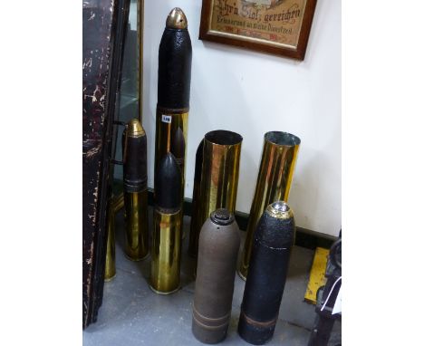 THREE LARGE HEAVY ARTILLERY SHELLS, ONE CASING WITH ENGRAVED TRENCH ART DECORATION TOGETHER WITH FIVE VARIOUS SMALLER EXAMPLE