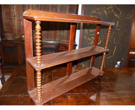 A VICTORIAN MAHOGANY THREE TIER WALL SHELF WITH BOBBIN SUPPORTS.   W.197cms.