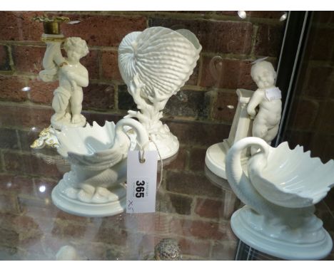 A GROUP OF FOUR ROYAL WORCESTER FIGURINES TO INCLUDE A PAIR OF DOLPHIN SUPPORTED SHELL DISHES, ANOTHER OF NAUTILUS SHAPE AND 