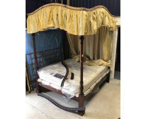 A modern mahogany framed and ebonised four poster bedstead in the late George III manner, the front posts of cluster column d