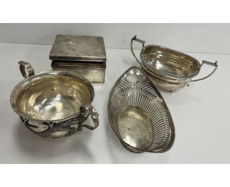 A 19th Century Chinese white metal bell shaped bowl with scroll handles on a circular foot, the main body decorated in relief