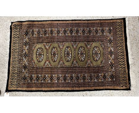 A collection of Bokhara type rugs of small size to include one set with single row of stylised elephant foot medallions on a 
