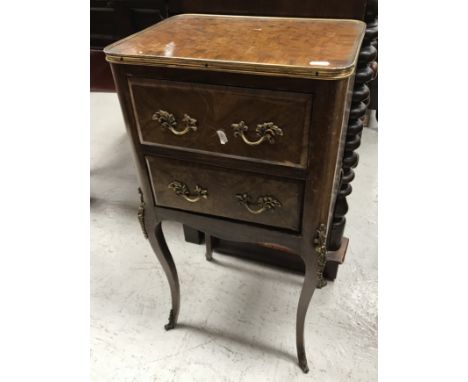 An early to mid 20th Century French walnut commode in the Louis XVI taste, the cube parquetry work and cross banded top with 