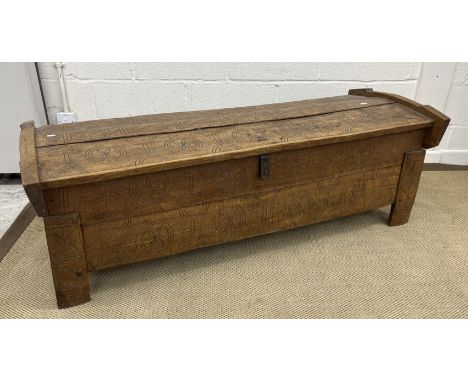A circa 1900 Scandinavian carved light oak coffer of domed form with flower head medallion decoration throughout raised on st