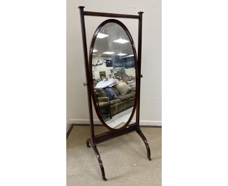 An Edwardian mahogany and inlaid cheval mirror with brass urn finials raised on splayed square tapered legs to castors 75 cm 