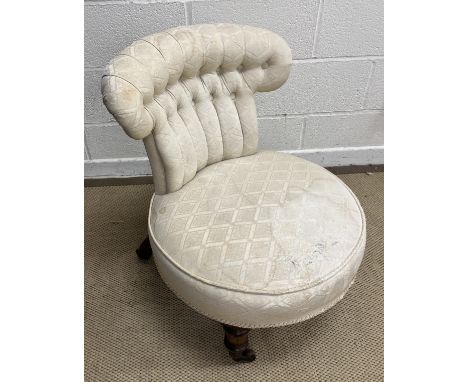 A Victorian spoon back salon chair, the show frame with carved top above button back and shaped seat to cabriole legs raised 