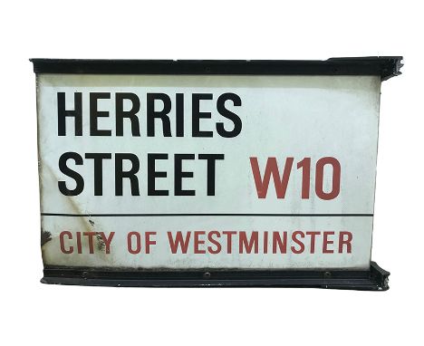 A double sided pole street sign for Herres Street W10,  City of Westminster with iconic black and red sans serif lettering fi