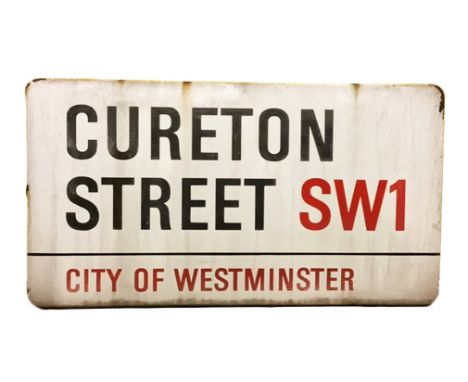 An enamelled steel street sign for Cureton Street SW1,  City of Westminster with iconic black and red sans serif lettering fi