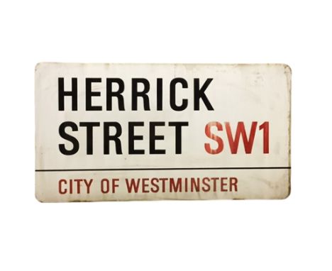 An enamelled steel street sign for Herrick Street SW1, City of Westminster with iconic black and red sans serif lettering fir