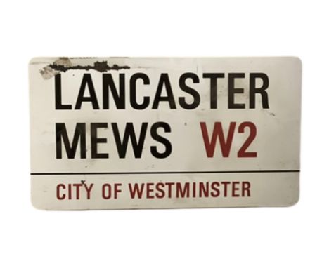 An enamelled steel street sign for Lancaster Mews W2, City of Westminster with iconic black and red sans serif lettering firs