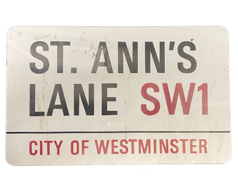An enamelled steel street sign for St. Ann's Lane SW1 City of Westminster with iconic black and red sans serif lettering firs