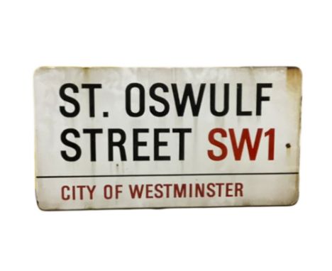 An enamelled steel street sign for St. Oswulf Street SW1 City of Westminster with iconic black and red sans serif lettering f