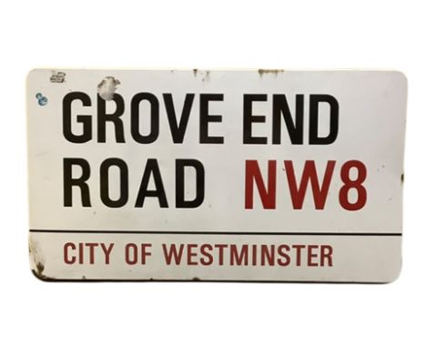 An enamelled steel street sign for Grove End Road NW8, City of Westminster with iconic black and red sans serif lettering fir