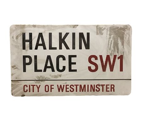An enamelled steel street sign for Halkin Place SW1, City of Westminster with iconic black and red sans serif lettering first
