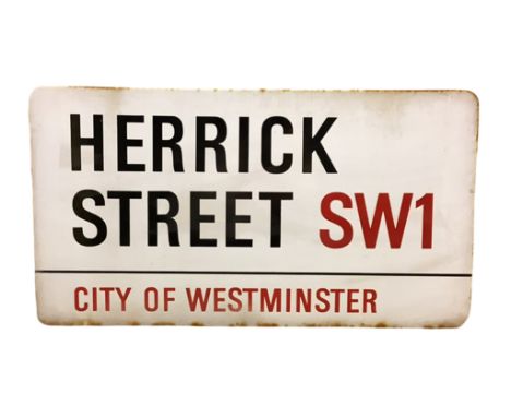 An enamelled steel street sign for Herrick Street SW1, City of Westminster with iconic black and red sans serif lettering fir
