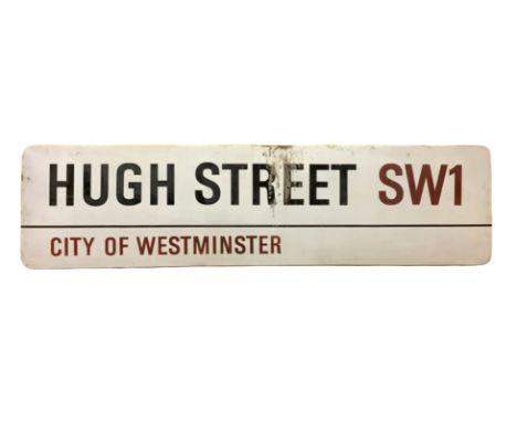 An enamelled steel street sign for Hugh Street SW1, City of Westminster with iconic black and red sans serif lettering first 