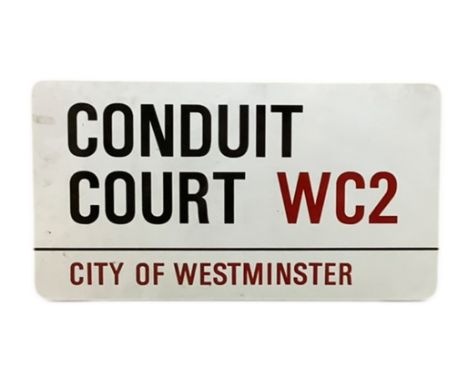 An enamelled steel street sign for Conduit Court WC2, City of Westminster with iconic black and red sans serif lettering firs