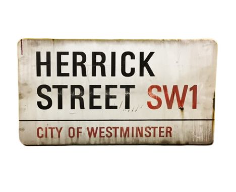 An enamelled steel street sign for Herrick Street SW1, City of Westminster with iconic black and red sans serif lettering fir