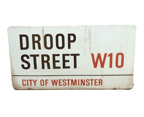 An enamelled steel street sign for Droop Street W10, City of Westminster with iconic black and red sans serif lettering first