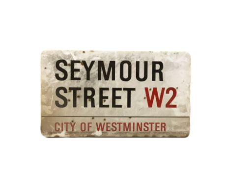 An enamelled steel street sign for Seymore Street W2, City of Westminster with iconic black and red sans serif lettering firs