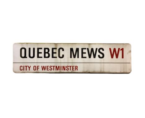An enamelled steel street sign for Queber Mews W1, City of Westminster with iconic black and red sans serif lettering first c