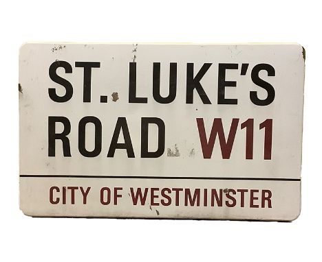 An enamelled steel street sign for St. Luke's Road W11, City of Westminster with iconic black and red sans serif lettering fi