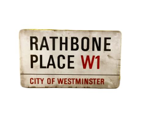 An enamelled steel street sign for Rathbone Place W1, City of Westminster with iconic black and red sans serif lettering firs