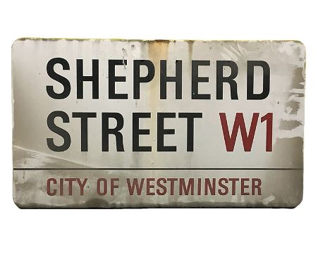 An enamelled steel street sign for Shepherd Street W1 City of Westminster with iconic black and red sans serif lettering firs