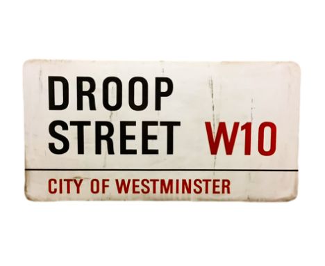 An enamelled steel street sign for Droop Street W10, City of Westminster with iconic black and red sans serif lettering first