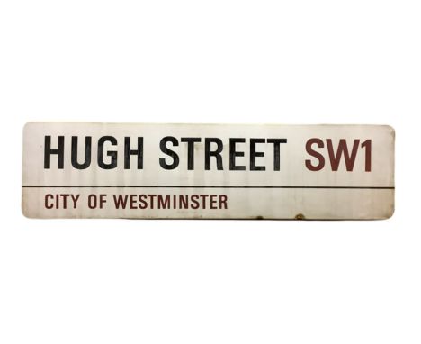 An enamelled steel street sign for Hugh Street SW1, City of Westminster with iconic black and red sans serif lettering first 