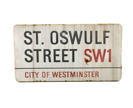 An enamelled steel street sign for St Oswulf Street City of Westminster with iconic black and red sans serif lettering first 