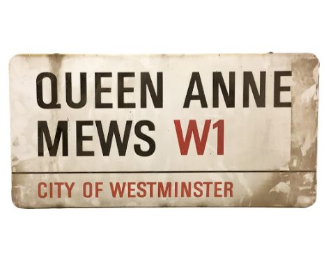 An enamelled steel street sign for Queen Anne Mews W1 City of Westminster with iconic black and red sans serif lettering firs