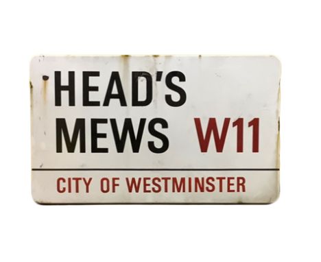 An enamelled steel street sign for Heads Mews W11City of Westminster with iconic black and red sans serif lettering first cre