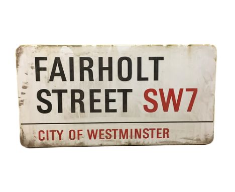 An enamelled steel street sign for Fairholt Street SW7, City of Westminster with iconic black and red sans serif lettering fi