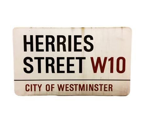 An enamelled steel street sign for Herries Street W10, City of Westminster with iconic black and red sans serif lettering fir