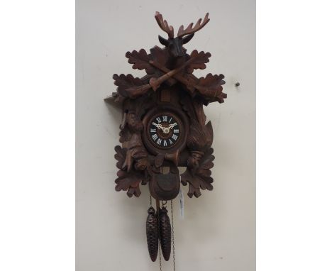 Black forest style carved wall hanging cuckoo clock  CLOCKS & BAROMETERS - as we are not a retailer, these items are sold as 