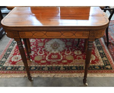 A 19th century mahogany and ebony strung card table with folding baize lined top on turned and reeded supports with casters, 