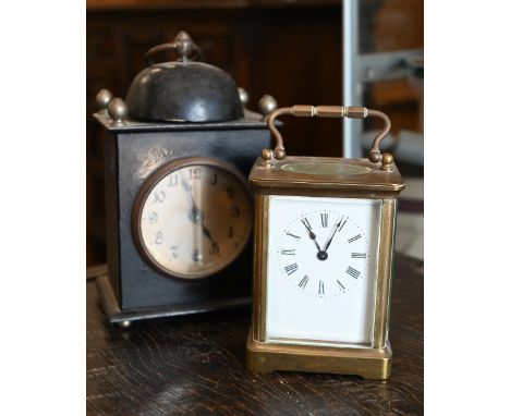 A French brass carriage clock, 15 cm high overall, to/w an American painted tin alarm clock (2) 