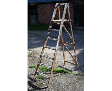 A vintage folding wooden paint-splashed stepladder