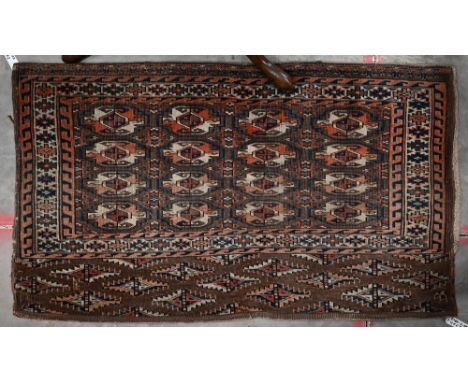 A vintage Turkoman brown and red geometric gul design bag-face, 125 cm x 73 cm 