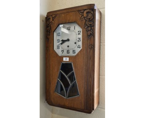 A German Art Deco oak wall clock with octagonal silvered dial, striking and chiming on gongs, 64 cm 